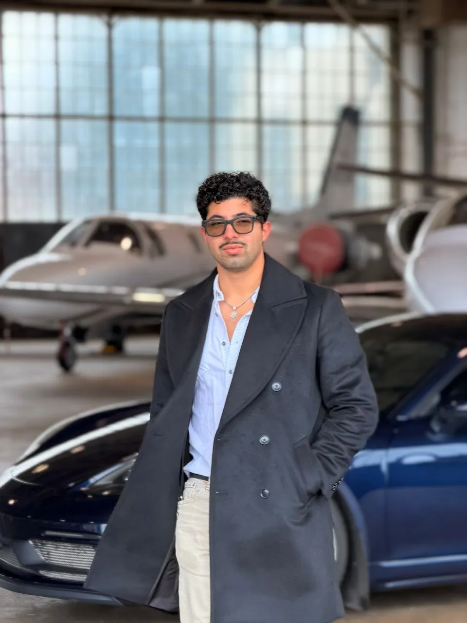 Diego Suarez, FAA Certificated Flight Instructor in Louisville, standing in an aircraft hangar with a business jet in the background